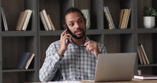Serious African male entrepreneur talk to client on the phone - Filmagem, Vídeo