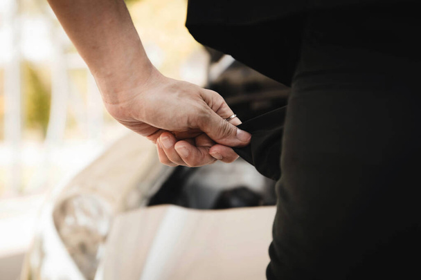 Concept no money : Closeup of a woman's hand, pulling the inside of the back pocket of the empty back, without money for a car repair expense : Selective Focus - Photo, Image