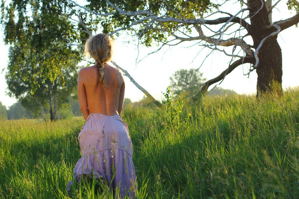 Sexy blond european girl relax in green summer meadow. Sunset in summer nature. - Foto, Imagem