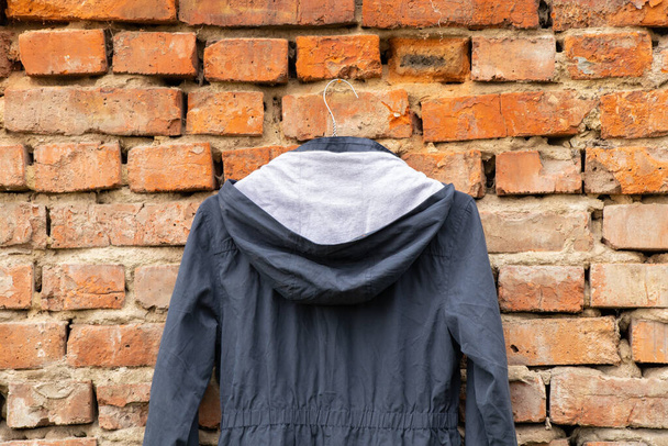 blue womens jacket weighs on hangers on the wall at home outdoors, womens jacket fashion - Photo, Image