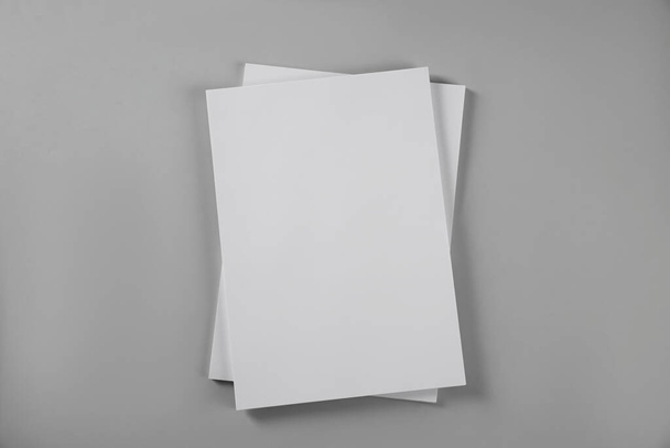 Blank brochures on grey background, top view. Mockup for design - Foto, Imagem