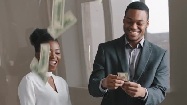 Ethnische Geschäftsleute feiern Erfolg. Afroamerikanische Männer und Frauen bekommen viel Geld und werfen hohe Dollarnoten in die Luft. Profitables Investment, gewinnträchtiges internationales Handelsgeschäft - Filmmaterial, Video