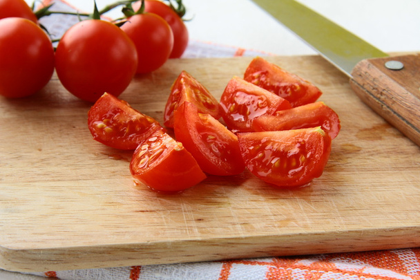 Fresh red sliced tomatoes on a wooden board - Fotografie, Obrázek