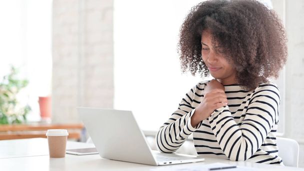 Tired African Woman with Laptop having Wrist Pain - Photo, image