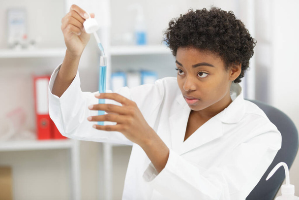 concentrated female scientist with test tubes - Photo, Image