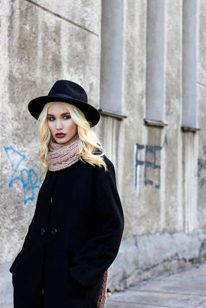 stylish beautiful woman in Hat walking in the city. Fshionable blond girl on the street - Photo, image