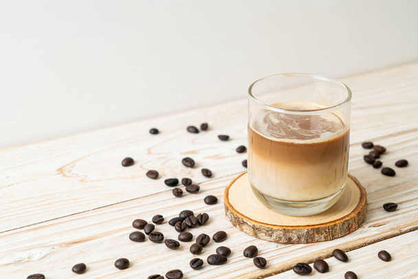 Dirty coffee glass, cold milk topped with hot espresso coffee shot - Foto, imagen