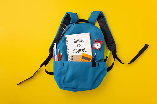 Concepto de regreso a la escuela con mochila y útiles escolares, vista superior - Foto, imagen
