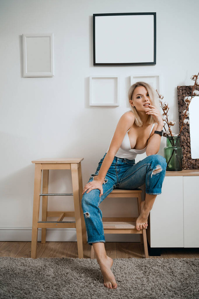 Blonde woman portrait sit in modern home interior - Photo, Image