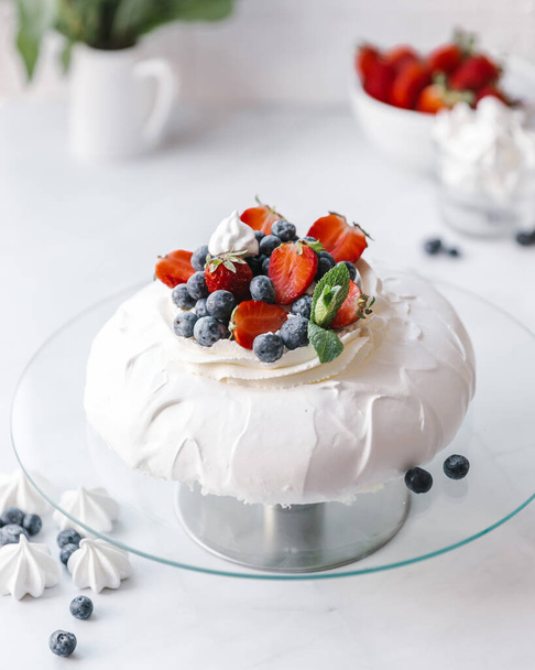 Homemade delicious meringue cake "Pavlova" with fresh straberry and mascarpone on a white background. - Photo, image