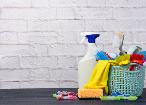 blue plastic basket with brushes, sponges and rubber gloves for cleaning, copy space - 写真・画像
