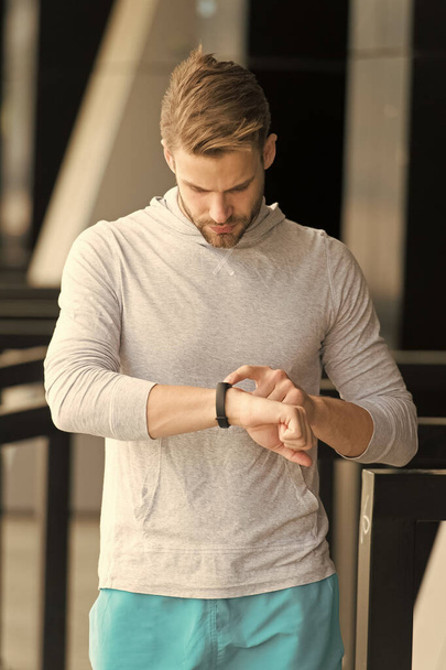 Best score. Monitoring concept. Check heart rate. Athletic man check smart watch. Handsome athlete use digital watch. Fitness tracking. Track distance and steps. Workout watch tracker. Sport gadgets - Φωτογραφία, εικόνα