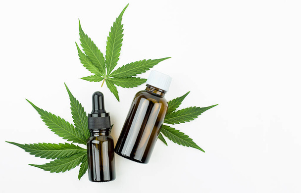 bottles with hemp oil on a light gray background. alternative medicine concept. top view - Photo, Image