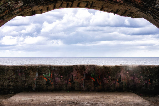 a view of the sea from the opening of a bunker on the shore - Photo, Image