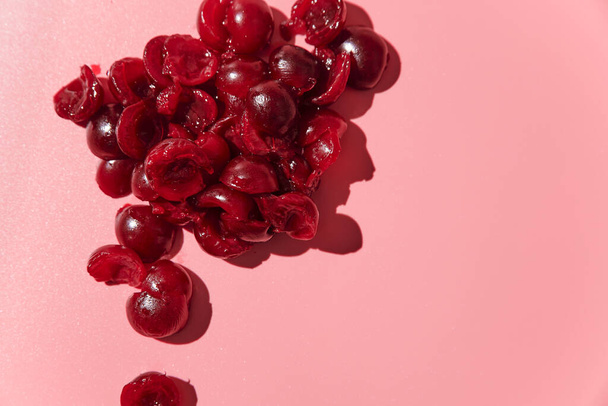 ripe peeled pitted cherries. pink background - Fotó, kép
