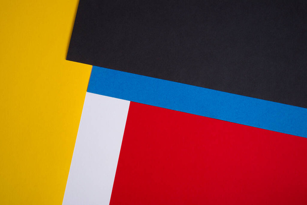 Yellow, black, blue, white and red colored paper background - Fotoğraf, Görsel
