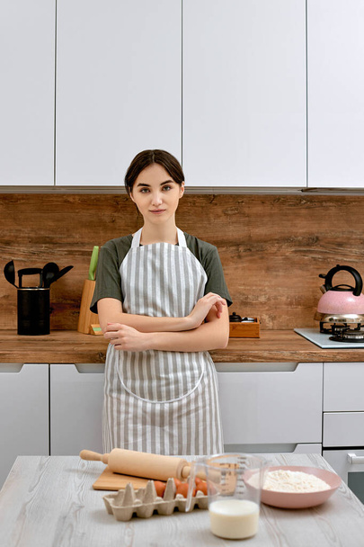 beautiful woman stands near table on kitchen - Photo, Image