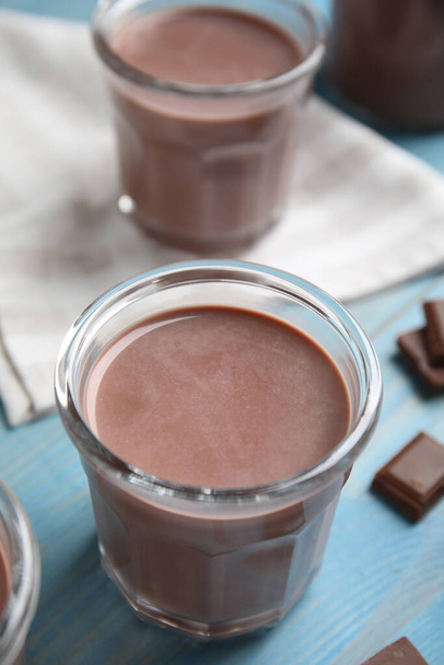 Delicious chocolate milk on light blue wooden table - Foto, immagini