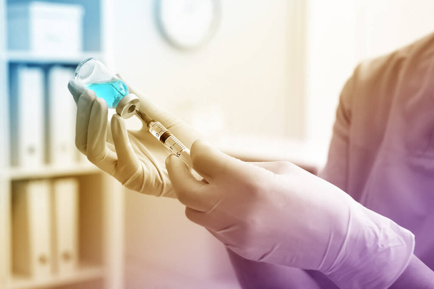 Doctor filling syringe with medication from vial in hospital, closeup - Φωτογραφία, εικόνα