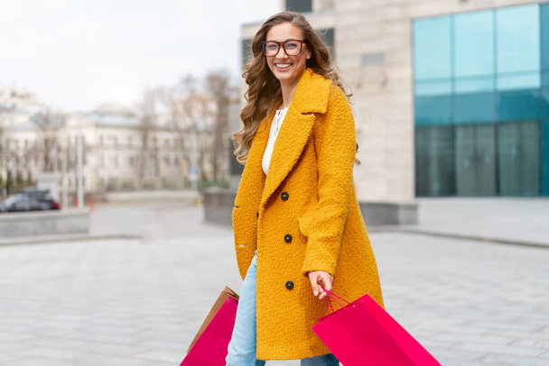 Business Woman With Shopping Bags Dressed Yellow Coat Walking Outdoors Corporative Building Background Caucasian Female Business Person Near Office Building Stylish Businesswoman Season Sale - Photo, Image