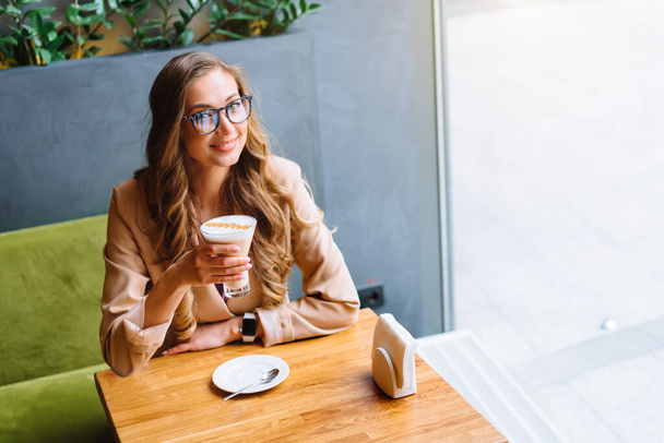 Business Woman Sitting Cafe Near Window Waiting Business Partner Caucasian Female Resting Cafeteria Drink Late Coffee Smile Looking outside - Photo, image