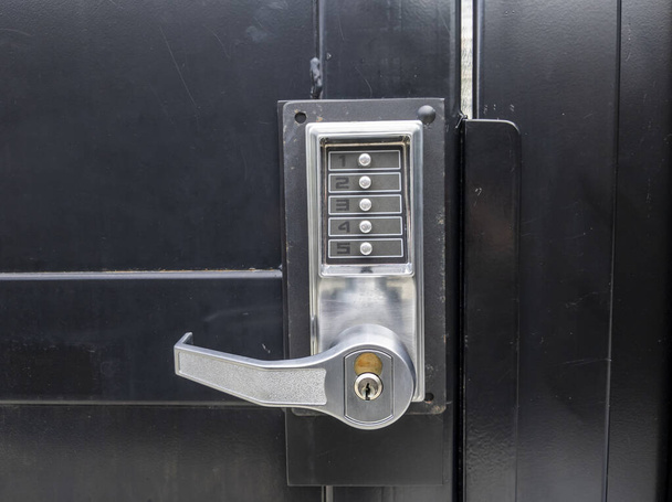 View of a secure pin lock keypad on a door in a big city's downtown area - Photo, Image