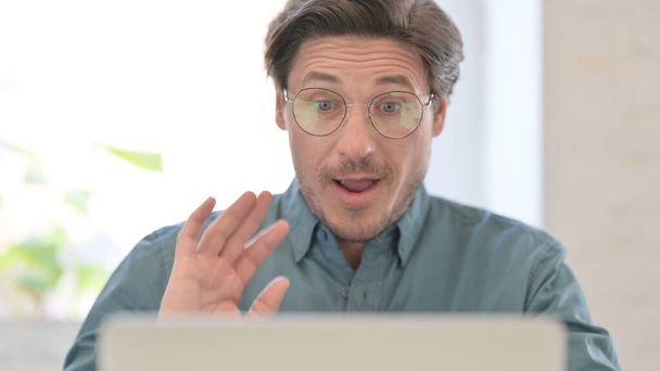 Portrait of Middle Aged Man Talking on Video Call on Laptop - Fotó, kép
