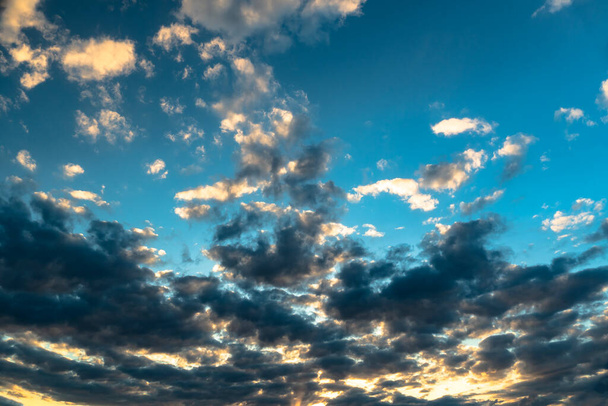 The heavenly light of the sun. Dramatic evening sky with clouds and rays of the sun. Sunlight at evening sunset or morning dawn.Panoramic view of the blue sky with clouds in motion. Blue skies - Photo, Image