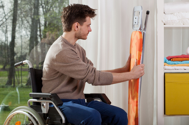 Disabled man before ironing - Photo, Image