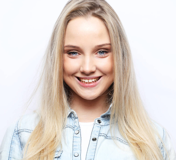 Lifestyle, emotion and people concept: Young cute smiling blond girl - Foto, imagen
