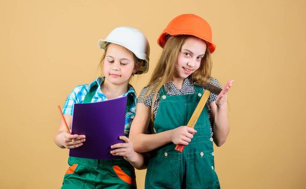 Kids happy renovating home. Home improvement activity. Kids girls with tools planning renovation. Family remodeling house. Children sisters renovation their room. Control renovation process - Fotoğraf, Görsel