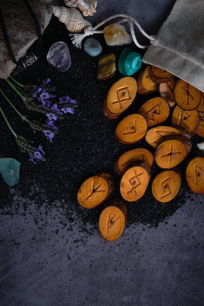 homemade wooden runes on a dark background - Fotó, kép