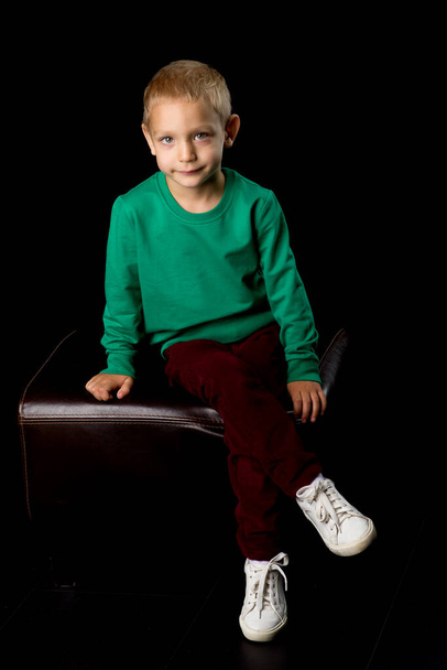 Cute Stylish Boy Posing Posing and Looking Up in Studio - Photo, Image