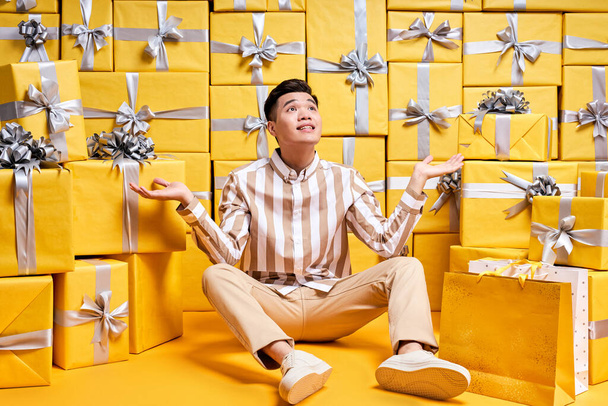 Asian Guy In Shock By Getting So Many Gifts Boxes, Looking Up - Photo, image