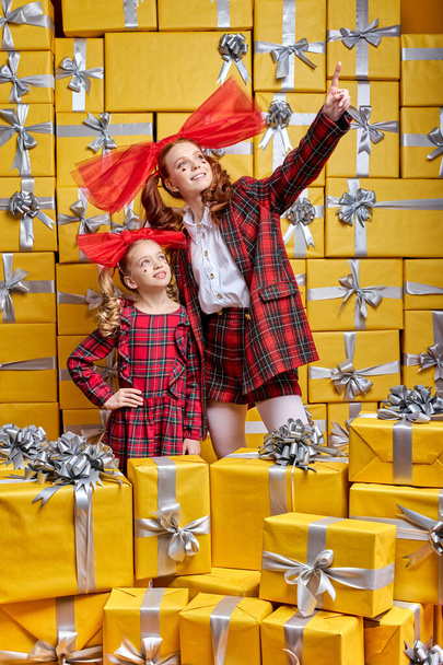 Pretty Woman With Child Girl Looking At Side Surprisingly, Surrounded By Packed Gifts Presents - Фото, изображение