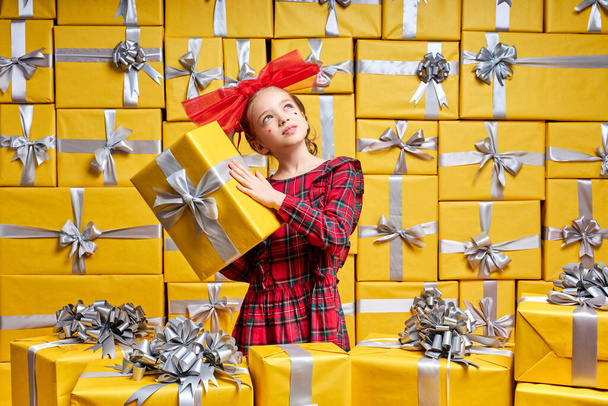 charming blonde girl holding gift box in hands wondering what is there. New Year Womens Day Birthday Holiday concept - Valokuva, kuva