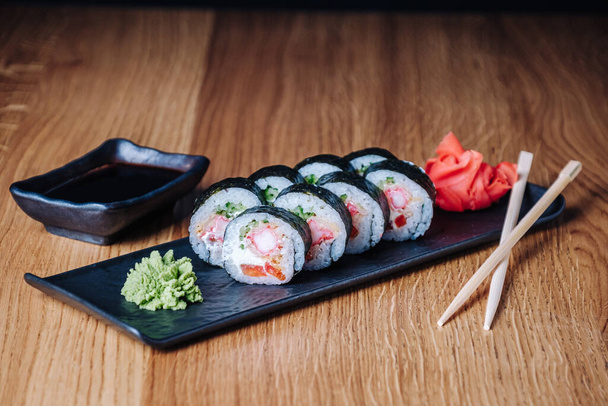 Sushi on a Wooden Table in Restaurant, Delicious Japanese Food, Sushi Rolls - 写真・画像