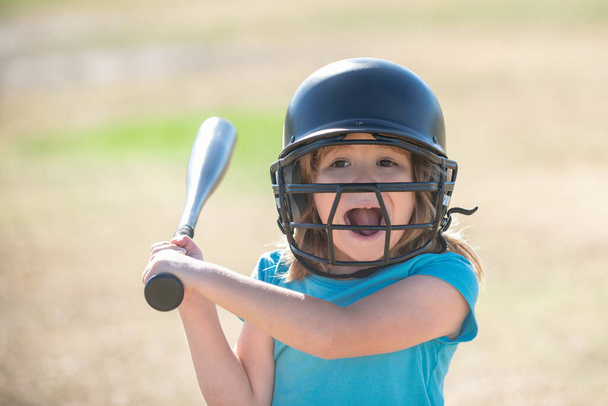 Funny kid up to bat at a baseball game. Close up portrait. - 写真・画像