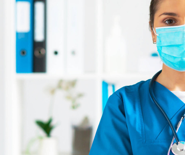 Professional medical doctor working in hospital office, Portrait of young and attractive female physician in protective mask. - Φωτογραφία, εικόνα