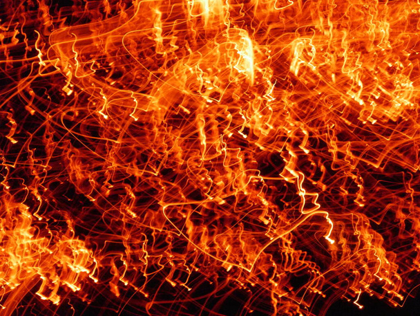 Fire flames with sparks on a black background.By shooting at high speed. - Photo, Image