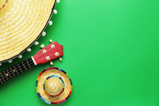 Mexican sombreros and guitar on color background - Фото, изображение