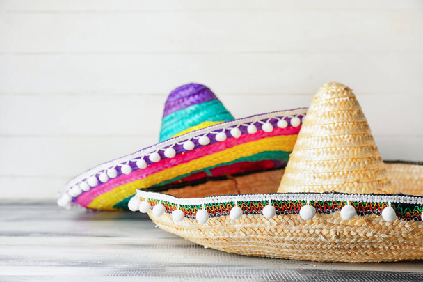 Mexican sombreros on wooden background, closeup - Foto, imagen