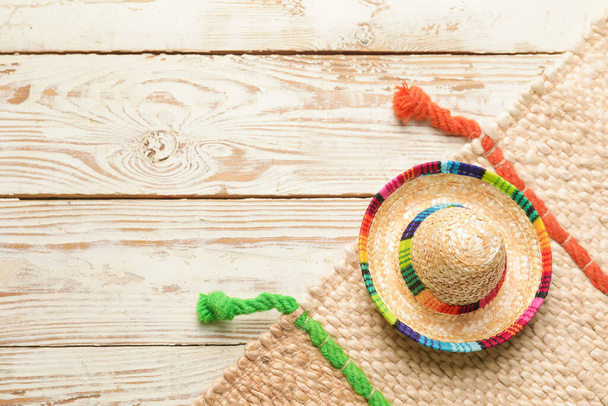 Mexican sombrero on light wooden background - Foto, Imagem