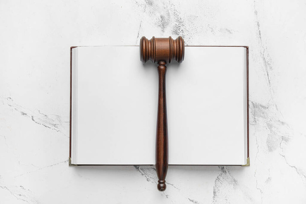 Judge's gavel and open book on light background - Photo, Image