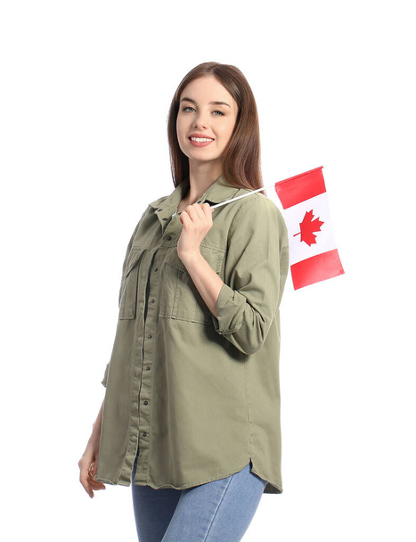 Beautiful young woman with Canadian flag on white background - Foto, imagen
