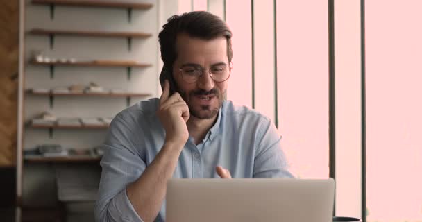 Businessman sit at workplace talk to client by phone - Felvétel, videó