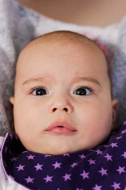 Portrait of cute baby close-up. Sweet little infant looks to camera - Photo, Image