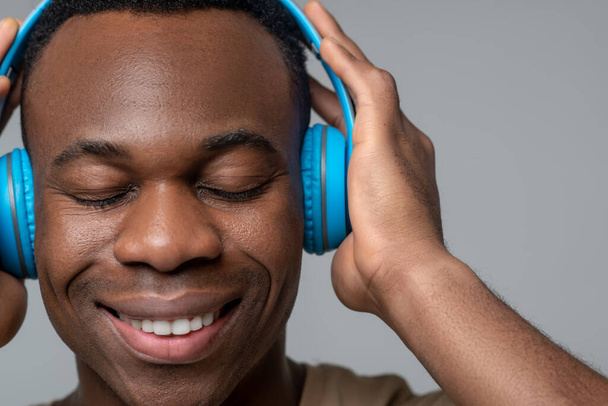 Satisfied face of african american in headphones - Foto, Imagen