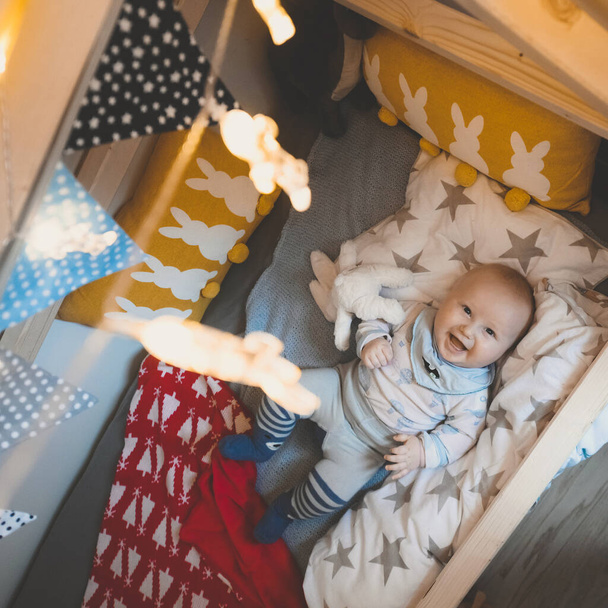 Portrait of cute baby boy in his house bed. Happy childhood - Foto, immagini