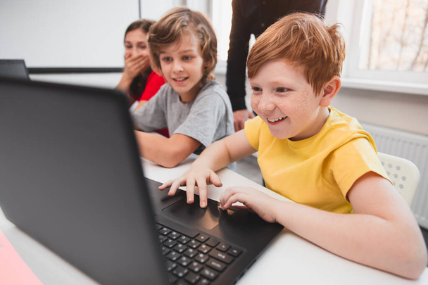 Company of children using laptops during programming lesson - Photo, Image